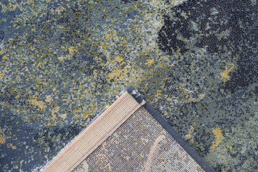 Omgeslagen hoek met de geweven rugzijde van het blauwe Tapison Home Torino 063.0934.5241 vloerkleed