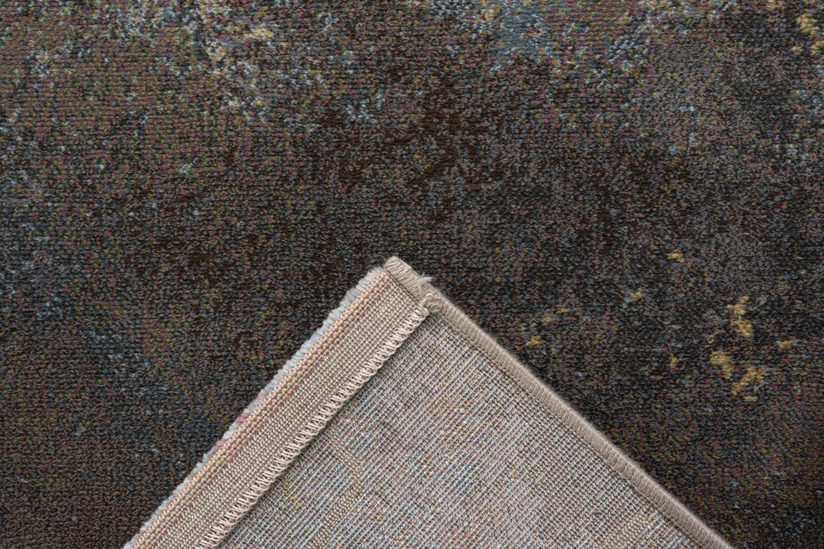 Omgeslagen hoek met de geweven rugzijde van het veelkleurige Tapison Home Torino 063.0934.7270 vloerkleed