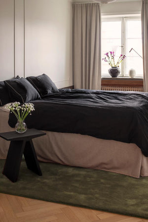 Layered Solid Wool Capulet Olive groen vloerkleed, in een slaapkamer
